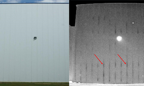 An infrared camera being used to perform a commercial refrigeration building survey, with the camera pointed at a refrigeration unit on the exterior of a building.